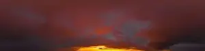 Dramatic dark burning red sunset sky panorama