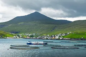 Dramatic morning view on Sandavagur village and fish farm on Vagar island, Faroe Islands, Denmark. Landscape photography