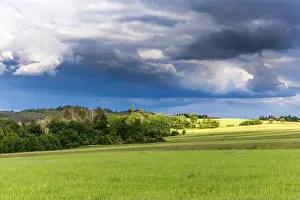 Gloomy Prints: Dramatic sky over green field. rain before