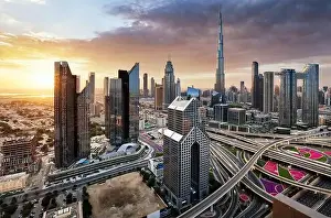 Skyline Tower Prints: Dramatic sunrise over Dubai skyline panorama with Burj Khalifa and luxury skyscrapers