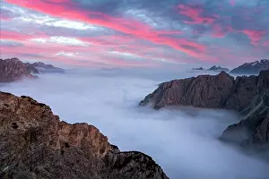 Dramatic sunrise landscape with flowing fog and pink skies in the Dolomites mountains. Location Auronzo rifugio in Tre Cime di Lavaredo National