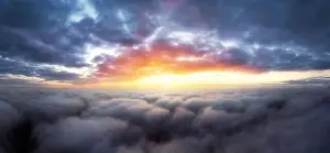 Stratosphere Prints: Dramatic sunrise sky above fluffy clouds early in the morning from aerial drone view