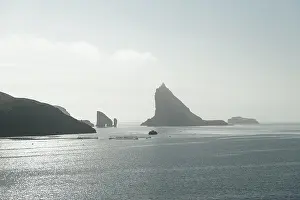 Dramatic view on Drangarnir and Tindholmur sea stacks in Atlantic ocean, Faroe Islands. Landscape photography