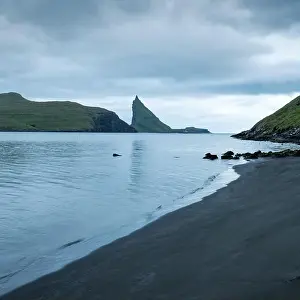 Dramatic view on Drangarnir and Tindholmur sea stacks in Atlantic ocean, Faroe Islands. Landscape photography