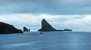 Dramatic view on Drangarnir and Tindholmur sea stacks in Atlantic ocean, Faroe Islands. Landscape photography