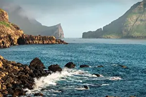 Dramatic view on Drangarnir and Tindholmur sea stacks in Atlantic ocean from Gasadalur village on Vagar island, Faroe Islands. Landscape photography