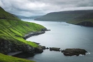 Images Dated 31st July 2019: Dramatic view of green hills of Vagar island and Sorvagur town on background. Faroe islands, Denmark