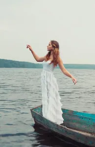 Glory Prints: dreamy mysterious blonde girl in a white dress in an old boat on the lake