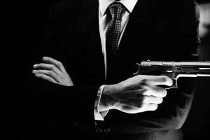 Mafia Prints: Well dressed male secret agent detective spy wearing suit and tie holding automatic pistol