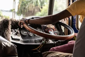 Steering Wheel Prints: A driver drives a bus in Asia. Close-up of the steering wheel and hands
