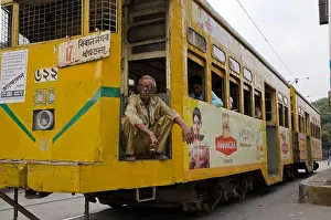Conveyance Prints: Driver of an old Kolkata tram having rest at a red traffic-light
