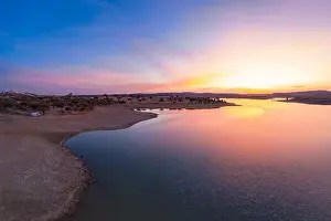 Reflection Lake Prints: Drone aerial panorama of a dam lake reservoir with a camper van at sunset in Terena