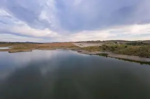 Reflection Lake Prints: Drone aerial panorama of a dam lake reservoir at sunset in Terena, Portugal