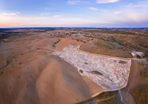 Reflection Lake Prints: Drone aerial panorama of a desert like hill landscape with marble stones dust at sunset in Terena