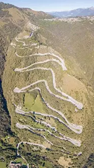 Up and down drone aerial view of the mountain road in Italy from the village of Nembro to Selvino
