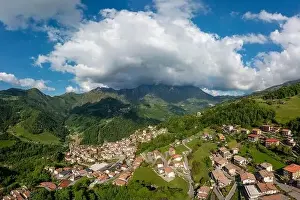 Town Hill Prints: Drone aerial view to the Seriana valley and Orobie Alps with big cloud and blue sky