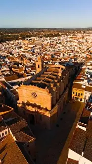 A drone captures the golden hues of sunset over the Ciutadella Cathedral located in Menorca