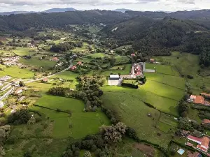 Green Landscape Prints: A drone captures the tranquil beauty of a green rural area with sports fields among rolling hills