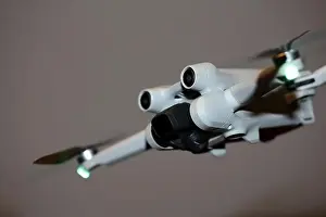 Piloting Prints: The drone copter flying with digital camera isolated on empty colorful background grey drones quad with sensors fly