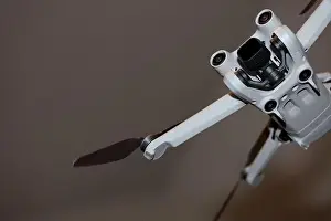 The drone copter flying with digital camera isolated on empty colorful background grey drones quad with sensors fly