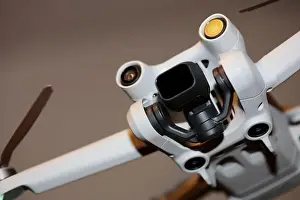 Piloting Prints: The drone copter flying with digital camera isolated on empty colorful background grey drones quad with sensors fly