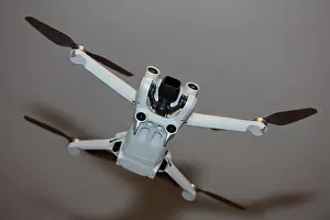 Piloting Prints: The drone copter flying with digital camera isolated on empty colorful background grey drones quad with sensors fly