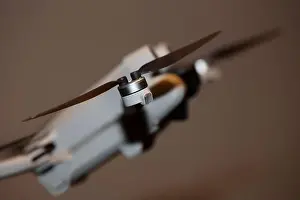 Piloting Prints: The drone copter flying with digital camera isolated on empty colorful background grey drones quad with sensors fly