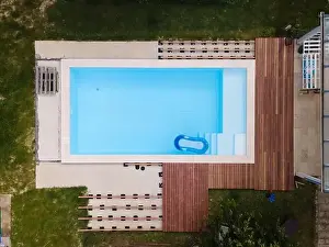 Hydro Massage Prints: Drone flight over beautiful green garden with pool and the wooden terrace of the pool is currently in progress