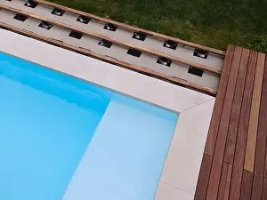 Above View Prints: Drone flight over beautiful green garden with pool and the wooden terrace of the pool is currently in progress