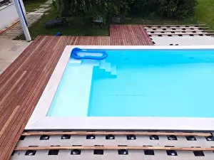 Above View Prints: Drone flight over beautiful green garden with pool and the wooden terrace of the pool is currently in progress