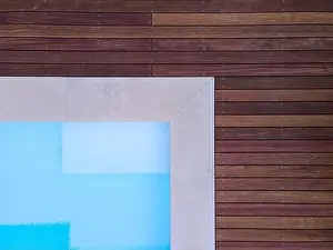 Above View Prints: Drone flight over beautiful green garden with pool and the wooden terrace of the pool is currently in progress