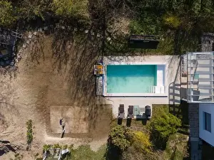 Drone flight over fresh earth area with grass grown next to pool construction site in April