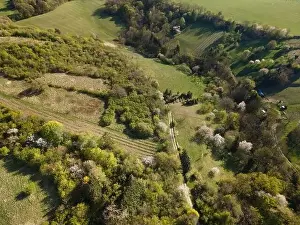 Spring Park Prints: Drone flight over green meadows, forests, landscape, nature in April in Austria