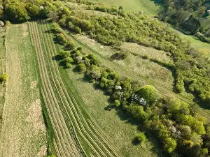 Drone flight over green meadows, forests, landscape, nature in April in Austria