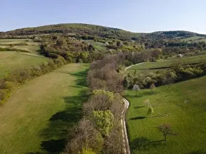 Drone flight over green meadows, forests, landscape, nature in April in Austria