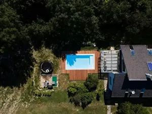 Above View Prints: Drone flight over pool with nice wooden terrace surrounded by green lawn in beautiful garden