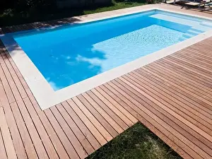 Above View Prints: Drone flight over pool with nice wooden terrace surrounded by green lawn in beautiful garden