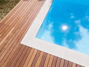 Above View Prints: Drone flight over pool with nice wooden terrace surrounded by green lawn in beautiful garden