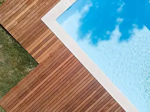 Above View Prints: Drone flight over pool with nice wooden terrace surrounded by green lawn in beautiful garden