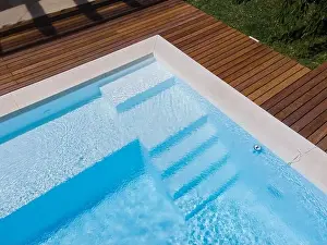 Above View Prints: Drone flight over pool with nice wooden terrace surrounded by green lawn in beautiful garden