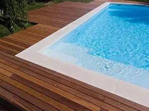 Above View Prints: Drone flight over pool with nice wooden terrace surrounded by green lawn in beautiful garden