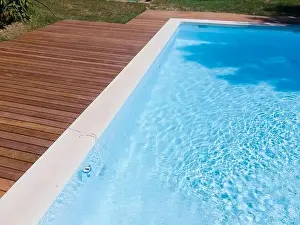 Above View Prints: Drone flight over pool with nice wooden terrace surrounded by green lawn in beautiful garden