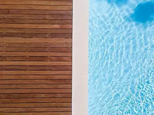 Above View Prints: Drone flight over pool with nice wooden terrace surrounded by green lawn in beautiful garden