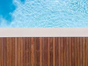 Above View Prints: Drone flight over pool with nice wooden terrace surrounded by green lawn in beautiful garden