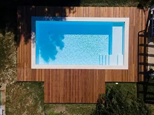 Above View Prints: Drone flight over pool with nice wooden terrace surrounded by green lawn in beautiful garden
