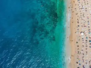 Drone footage of people sunbathing on Kaputaş beach near Kalkan - Kaş, Antalya, Turkey