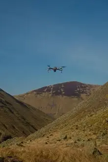 Hovering Prints: A Drone Hovers Above Hills and Valley in the Scottish Borders on a Sunny Day