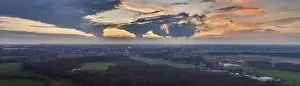 Drone image of the evening sky of the German industrial region of the Ruhr with several chimneys emitting large