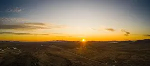 Sunset Landscape Prints: Drone panorama of a sunset over the Sonoran desert of Arizona with partly cloudy skies