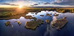 A drone photo of lake - pond bog with sun - Absolutely stunning aerial landscape sunset panorama